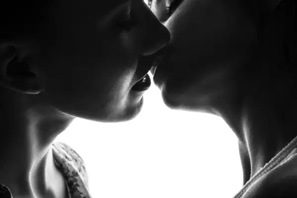Silhouette for women kissing each other. Black and White photo on a white background.