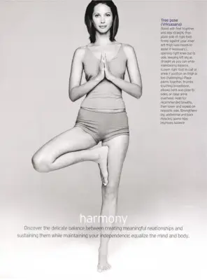 Christy Turlington standing in Tree Pose practicing yoga in a SHAPE Magazine article