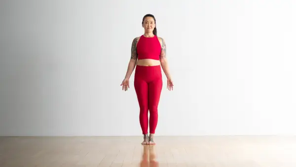 A woman wearing cream colored tights and top practices Child