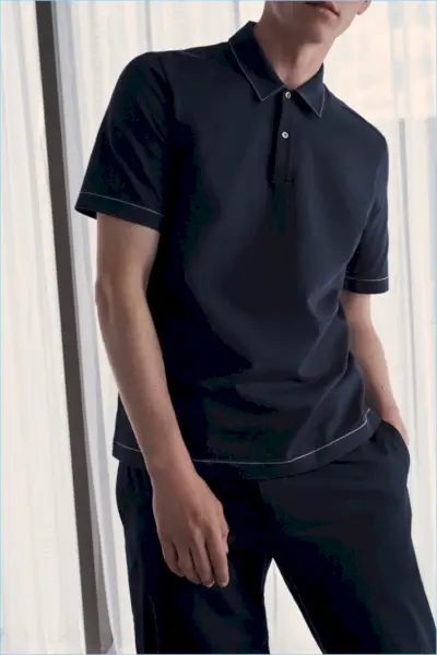 모델 앤더스 헤이워드(Anders Hayward)는 네이비 컬러의 COS 스티치 디테일 폴로 셔츠를 착용했습니다.