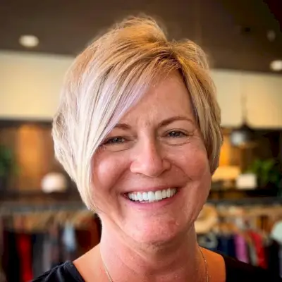 Asymmetrical haircut with layering for women in their 60s with fine Hair