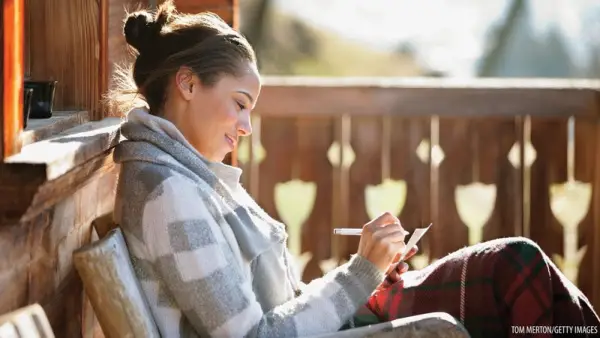 woman writing a thank you note
