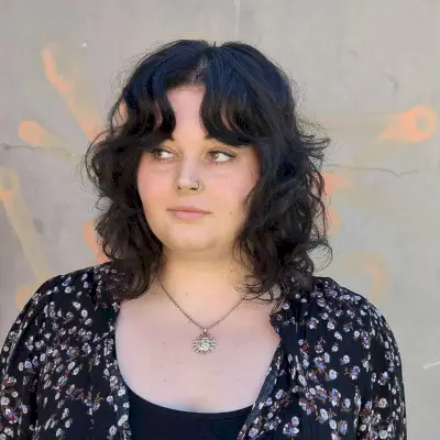 Mid-Length Shag with Parted Bangs for Round Faces