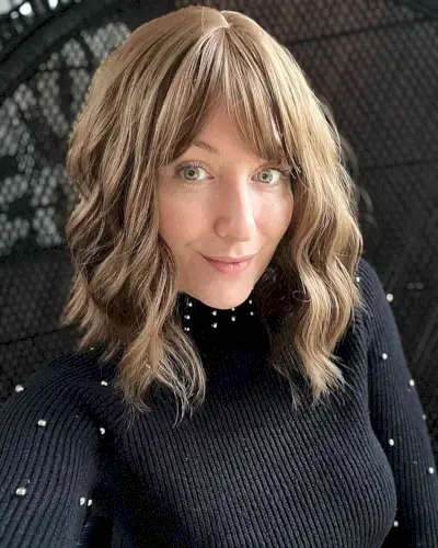 Medium hairstyle with angled bangs and long layers