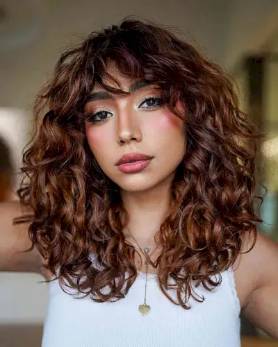 Gorgeous Medium Curls with Short Sweeping Bangs for women with prominent cheekbones