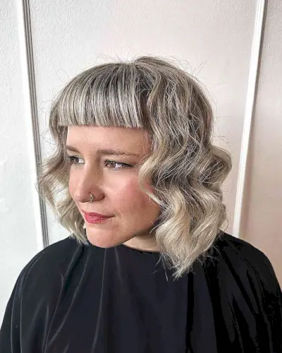 Short and Thick Straight Bangs for women with balayage and bablights in their hair