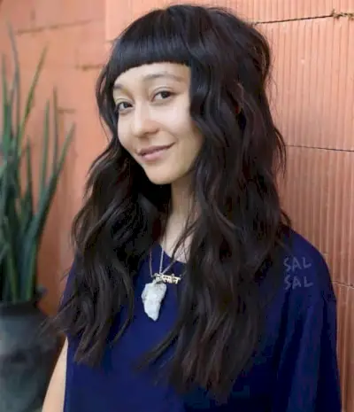 long hair with short bangs and beach waves