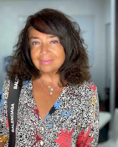 curly hair with side-swept bangs for women over 50