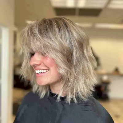 Shoulder-Length Angled Bob with Soft Beach Waves and Bangs