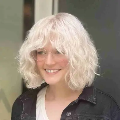 Neck-Length Bob Cut with Beachy Waves and Bangs for Thick Hair