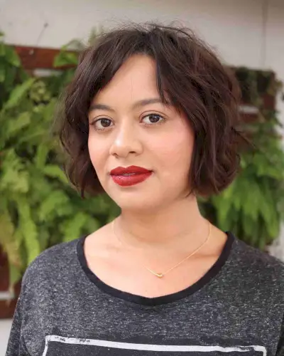 Short Textured Wavy Bob Cut with a Side Part and Bangs