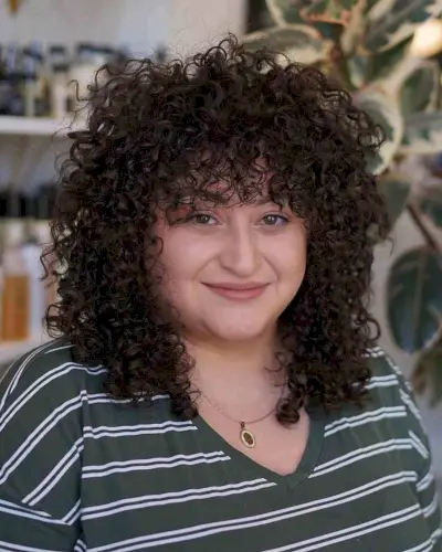 Beautiful curly bangs for curly hair and round face shape