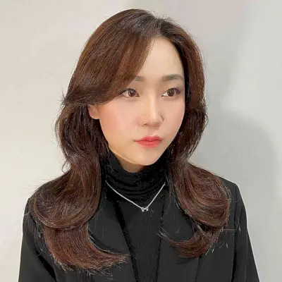 Voluminous Soft Waves and Side Bangs for Round-Shaped Faces and Brown Hair