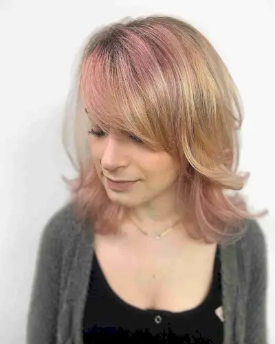 Thick Side Bangs and Medium-Length Layers on Edgy Blonde Hair with Pink Highlights