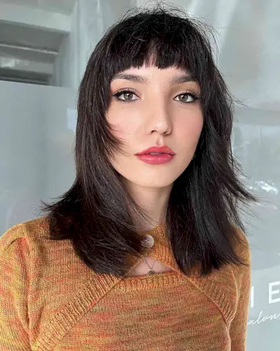 Choppy Curved Bangs on a layered medium cut for a heart face shape