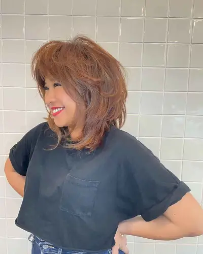 Voluminous Wolf Haircut with Feathered Bangs