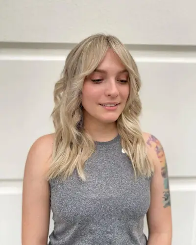 Wavy Blonde Shag with Curtain Bangs