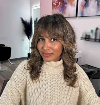 Full French Bangs with Feathery Ends on Medium-Length Brunette Hair