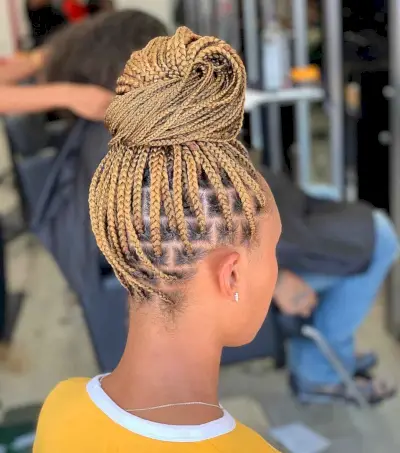 Blonde box braids in a top bun