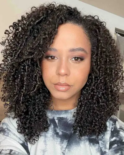 black woman with medium-length hair and tight ringlets