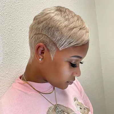 A women with short gold pixie haircut