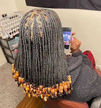 Shoulder-Length Black Knotless Braids with Orange Beads for Thick Hair