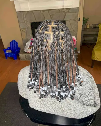 Mid-Length Black Knotless Braids with Brown Highlights and Black-White Beads