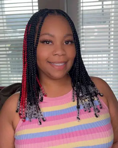 Middle-Parted Medium Knotless Stitch Braids with Beads and Red Plaits