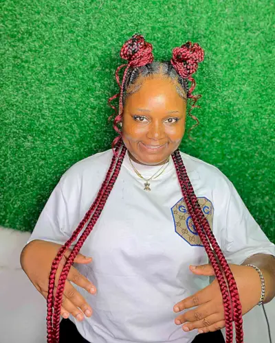 Long Vibrant Red Braids with Half-Up Space Buns for a Black Woman