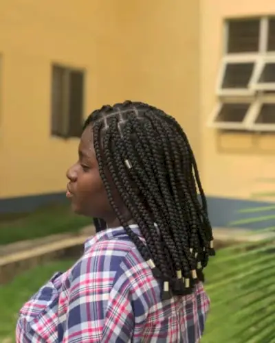 Collarbone length box braids with gold cuffs