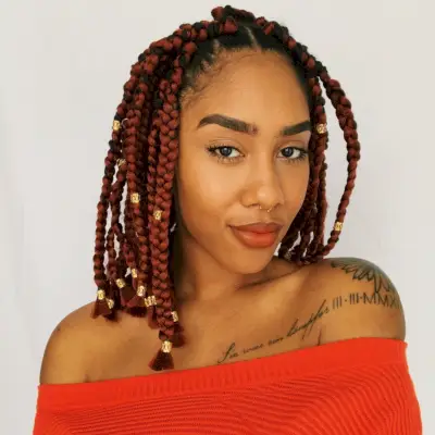medium-length box braids with gold cuffs