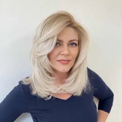 medium-length white blonde with feathered layers