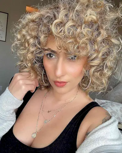 Neck-Length Dimensional Blonde Curly Hair and Curly Bangs with Layers