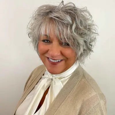 curly bob with straight bangs for women over 60