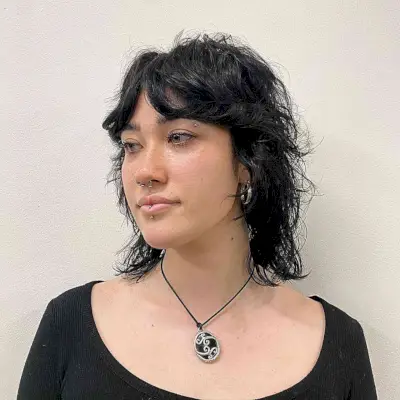 Mid-Length Razored Wolf Bob Haircut with Parted Bangs