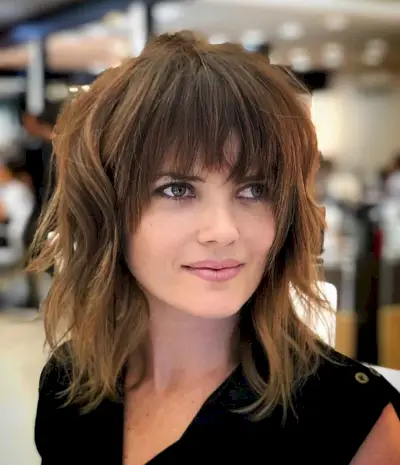 Perfect dark wavy angled bob with wispy bangs