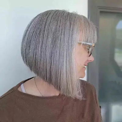 Neck-Length Angled Inverted Grey Bob with Fringe on Older Ladies
