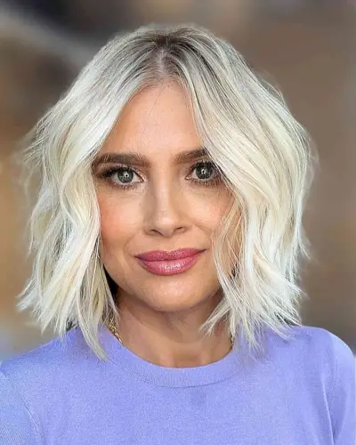 Rooted Light Blonde Lived-In Bob with a middle part and choppy blunt ends