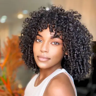 voluminous curly long bob with curly bangs