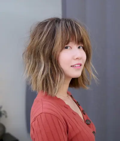 flattering choppy long bob with bangs for round face