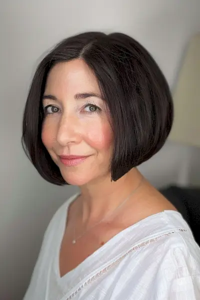 Chin-length graduated bob with side part on a woman with medium-density, straight hair