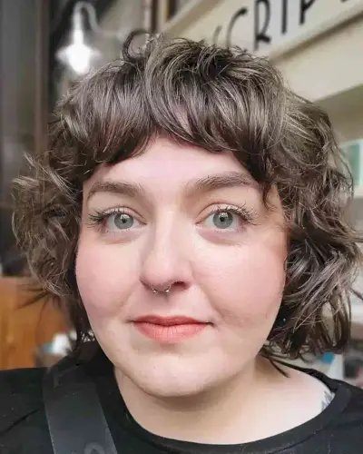 Jaw-Grazing Mini Curly Bob and Bangs for chubbier faces