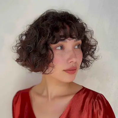 Curly A-Line Bob Haircut with Short Bangs