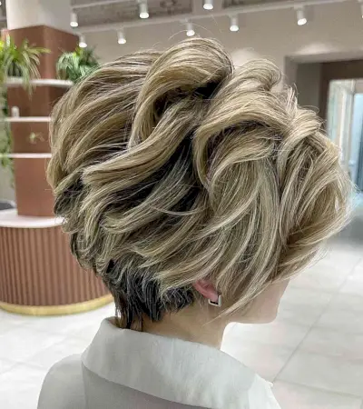 Visible Layers on a Long Pixie Bob Cut with blonde highlights and dark roots