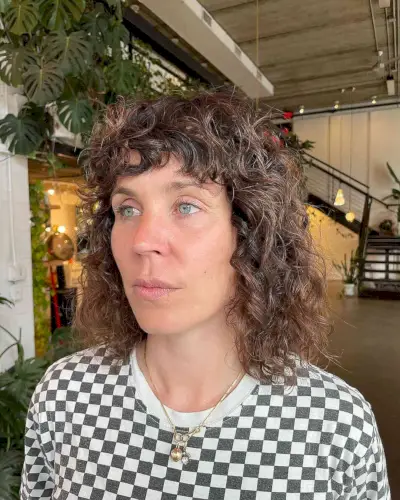 Long Curly Bob with Bangs on Women Over 50 with Thinning Hair