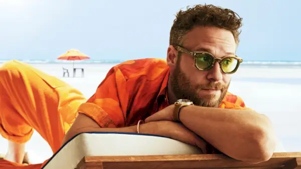 Skuespiller Seth Rogen bærer en Dries Van Noten-skjorte, The Elder Statesman-bukser, White Mountaineering x Jacques Marie Mage-solbriller og Tudor-ur.