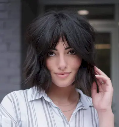 Play with the chin-length shag cut by pairing it with middle-parted bangs. A hairstyle like this requires a specific density of hair. For beauties with thick tresses, this is perfect! When styling, jazz it up with soft waves. That