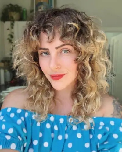 Choppy Curly Hair with Dark-Rooted Blonde Color