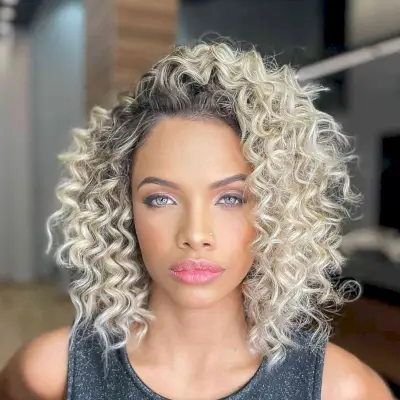 Shoulder-Length Blonde Curls with Dark Roots