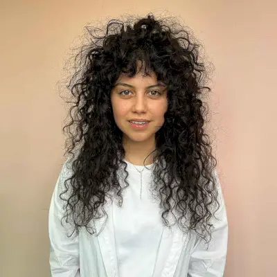 Wolf Cut with Choppy Layers and Curly Bangs for Thick Hair